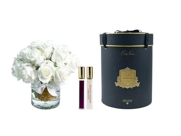 Composition parfumée Côte Noire : boutons de rose blanc pur ultra réalistes présentés dans une boîte noire satinée ornée d’un badge doré. L’élégance florale intuitive pour sublimer vos intérieurs.


- Marque : Côte Noire &nbsp;
- Composition : boutons de rose blanc real-touch &nbsp;
- Présentation : boîte noire satinée avec badge doré &nbsp;
- Arrangés dans gel transparent effet eau &nbsp;
- Inclus : sprays parfumaux Rose Oud &amp; Rose Pétale &nbsp;
- Parfum : notes florales délicates et boisées