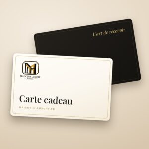 Carte cadeau Maison H, carte ivoire et or posée devant une carte noire « L’art de recevoir »